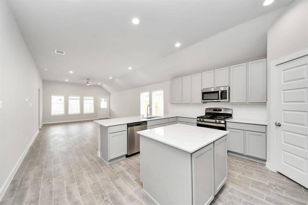 This kitchen is by far any chef’s dream! This spacious kitchen features high ceilings, lightstained wood cabinets, granite countertop, SS appliances, modern tile backsplash,recessed lighting, extended counter space, granite kitchen island, space for breakfast bar, and a walk-in pantry all overlooking your huge family room. Sample photo of completed home with similar floor plan. Actual colors and selections may vary.