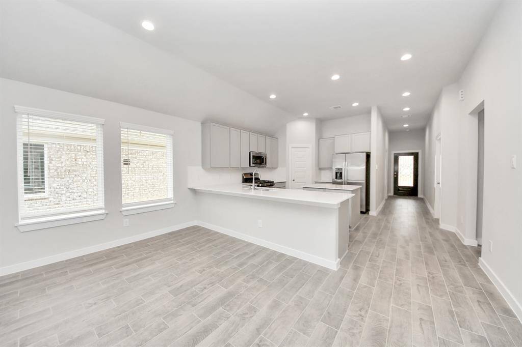 All this opens up to the expansive family room, creating a perfect hub forgatherings. Sample photo of completed home with similar floor plan. Actual colors and selections may vary.