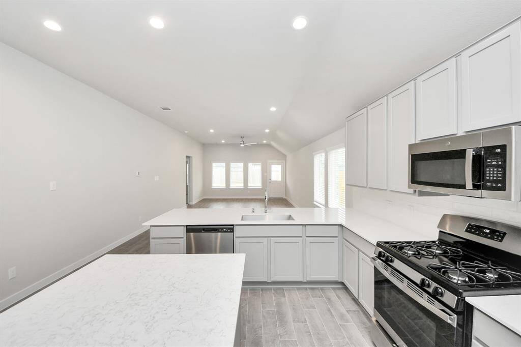 Discover another perspective of this stunning kitchen, generously appointedwith an abundance of counter space. Sample photo of completed home with similar floor plan. Actual colors and selections may vary.