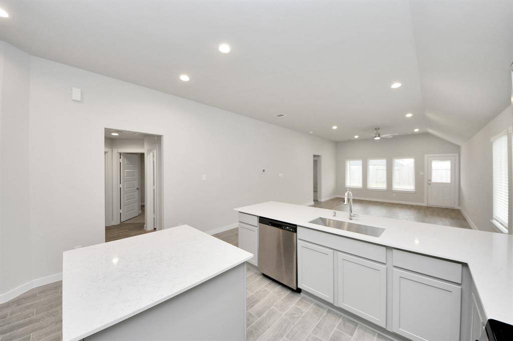 All of this overlooks your expansive family room, creating a perfect space forculinary delights and family gatherings. Sample photo of completed home with similar floor plan. Actual colors and selections may vary.
