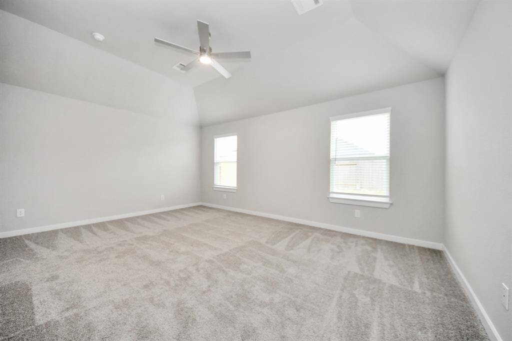 Escape and relax in the exquisite primary suite, a haven to unwind after a long day. Thespacious room, located on first floor, boasts plush carpeting, soothing paint tones, highceilings, and expansive windows adorned with privacy blinds. Sample photo of completed home with similar floor plan. Actual colors and selections may vary.
