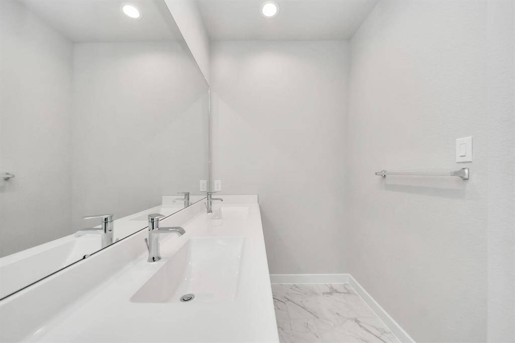 Escape to a spa-like oasis in this primary bathroom. Enjoy a walk-in showerwith tile surround, a separate garden tub with custom detailing, and an elegantvanity featuring light countertops, modern hardware, and beautiful recessed lights.Experience luxury and relaxation in every detail. Sample photo of completed home with similar floor plan. Actual colors and selections may vary.