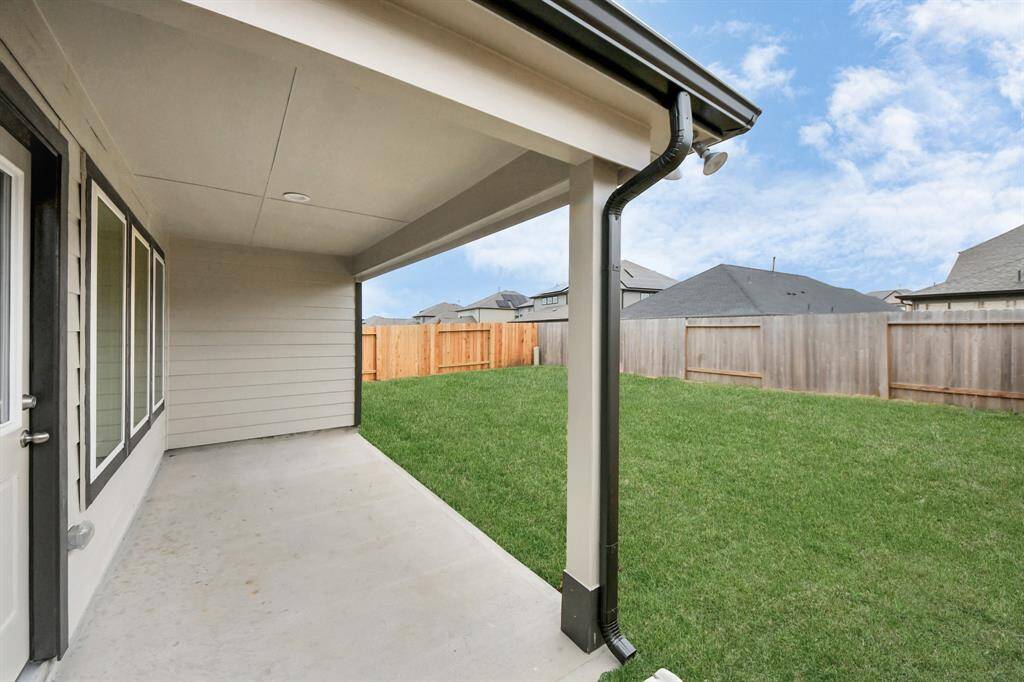 Experience outdoor living at its finest on this expansive covered patio,thoughtfully designed for BBQs and delightful outdoor dining. Sample photo of completed home with similar floor plan. Actual colors and selections may vary.