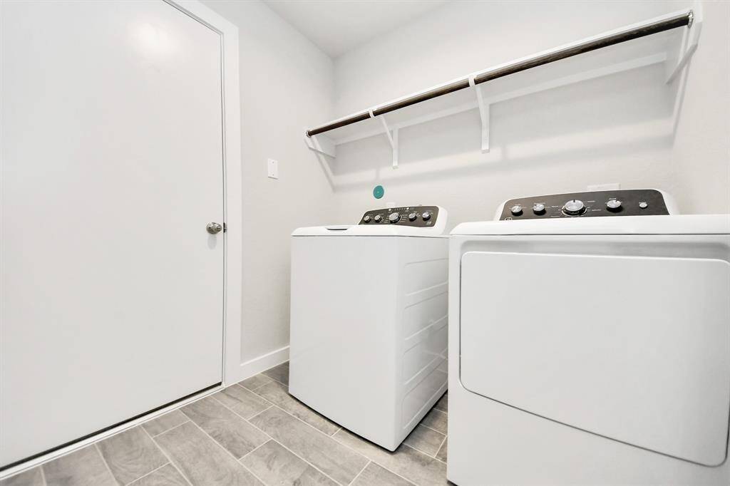 A perfect blend of functionality and comfort. Capture the essence of easy living with a first-floor laundry room, thoughtfully equipped with shelving for effortless organization. Bothelectric and gas connections available. Sample photo of completed home with similar floor plan. Actual colors and selections may vary.
