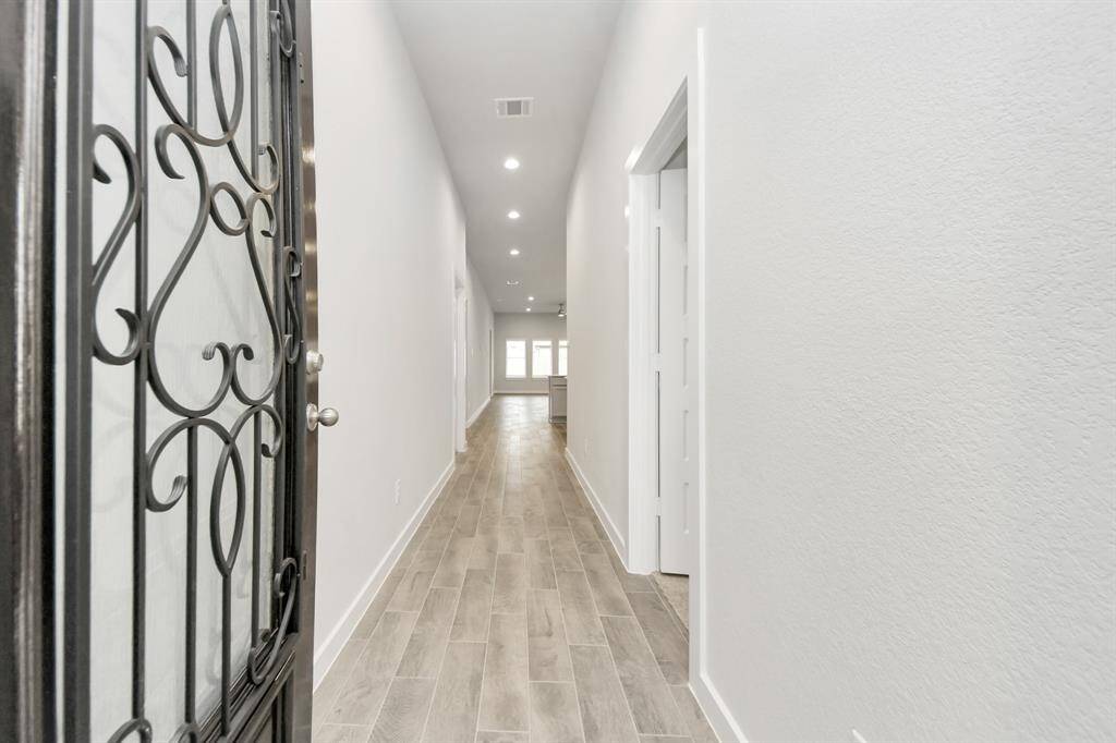 As you step into the threshold of this luxurious home, you'll soon be welcomed by anelegant glass door. Inside, soaring ceilings amplify the spaciousness,while the refined wood-look tile flooring and oversized baseboards exudesophistication and charm. Sample photo of completed home with similar floor plan. Actual colors and selections may vary.