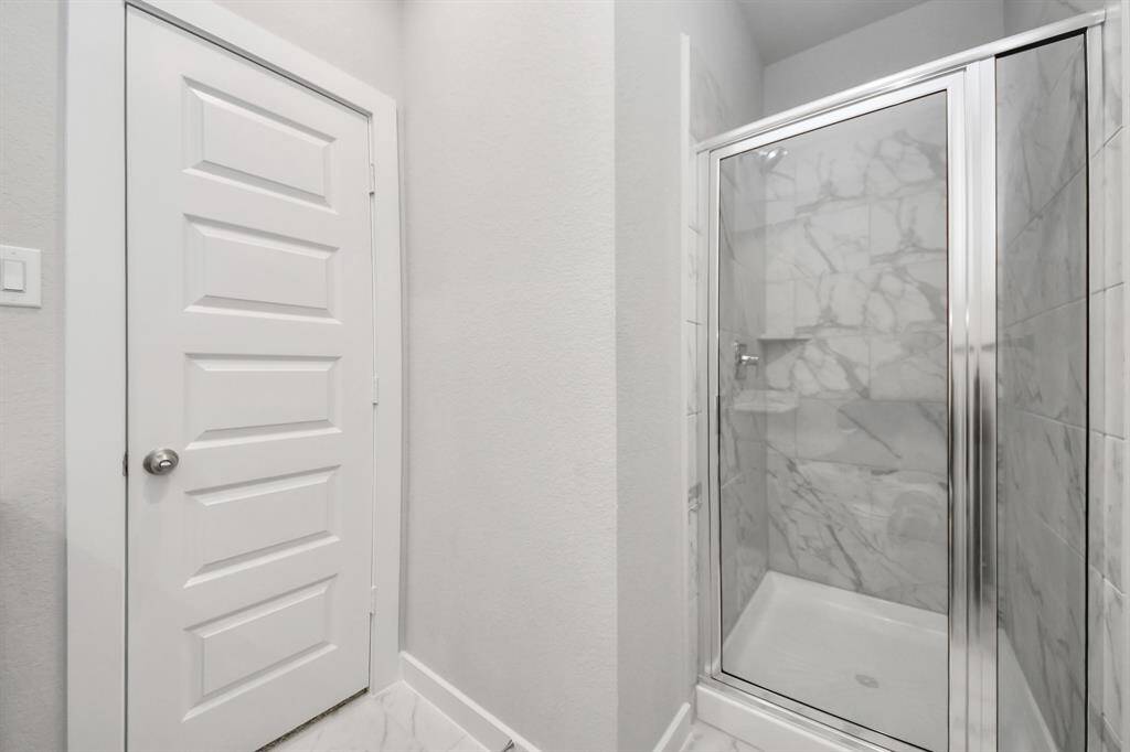 Experience sophistication in the guest suite bathroom, where tile flooringcomplements a walk-in shower with tile surround. Light wood cabinets completewith a beautiful light countertop, enhances the space for a truly invitingambiance. Sample photo of completed home with similar floor plan. Actual colors and selections may vary.