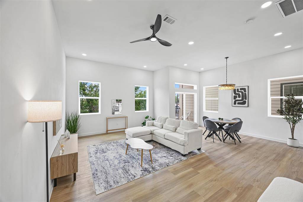 Spacious living room filled with natural light, perfect for relaxing or entertaining.