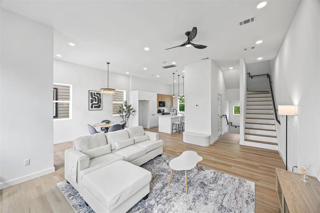 Open-concept second floor with a sleek kitchen, spacious living area, and powder room, perfect for everyday living and entertaining.