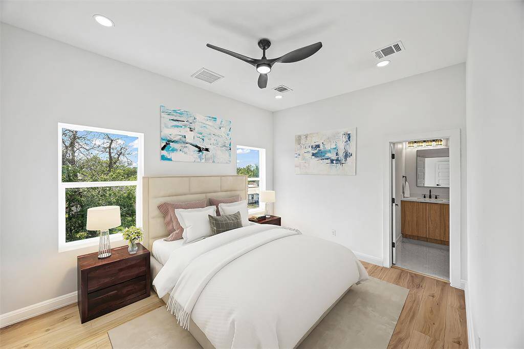 Spacious third-floor primary suite with large windows and a peaceful atmosphere.