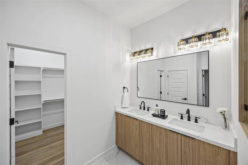 Elegant primary bathroom with a double vanity, perfect for sharing or added space.