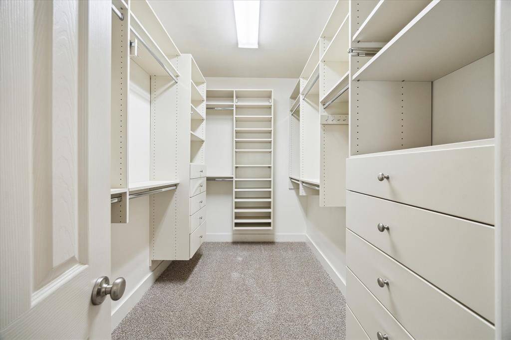 Massive walk-in closet with custom built-ins.