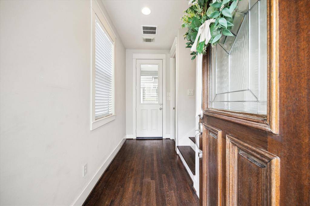 Door leading to the back porch with a small backyard space.