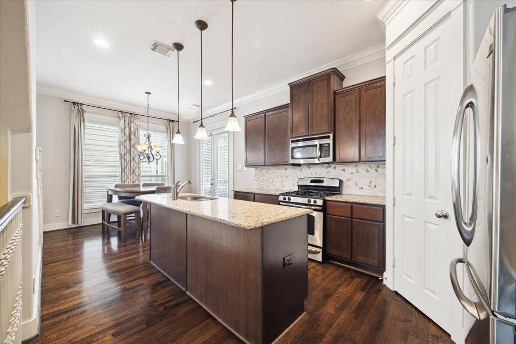 Hardwood floors throughout the kitchen and living areas.