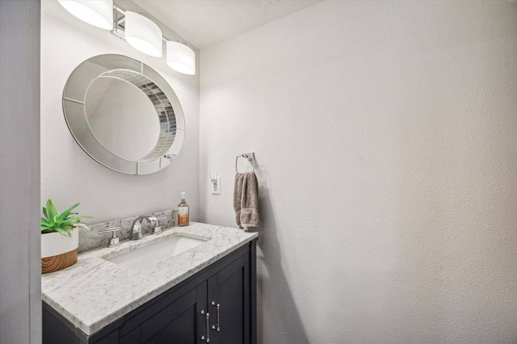 The powder room is nestled under the staircase.