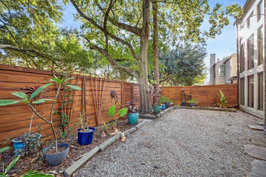 Right outside the dining room you have a manicured outdoor space with mature trees.