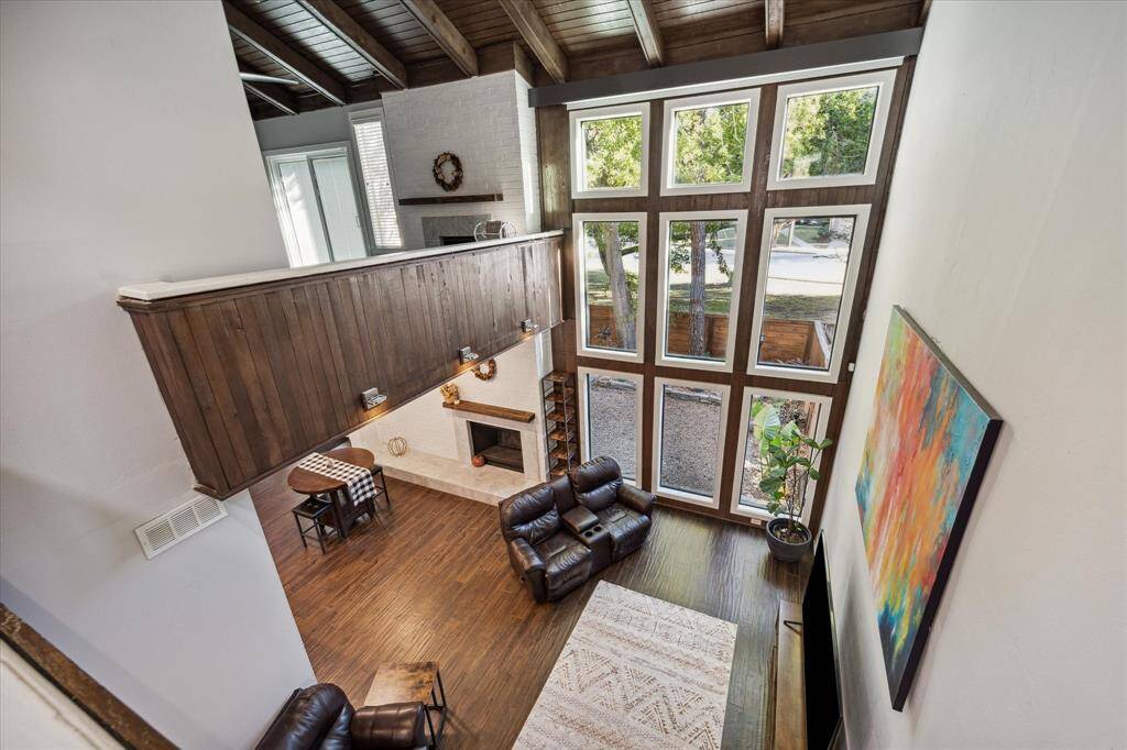 What a view from the open upstairs hallway. Electric blinds have been added to the wall of windows.