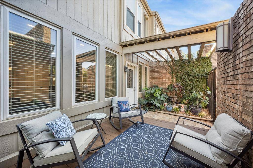 The home features a deck and lush vegetation in the front.