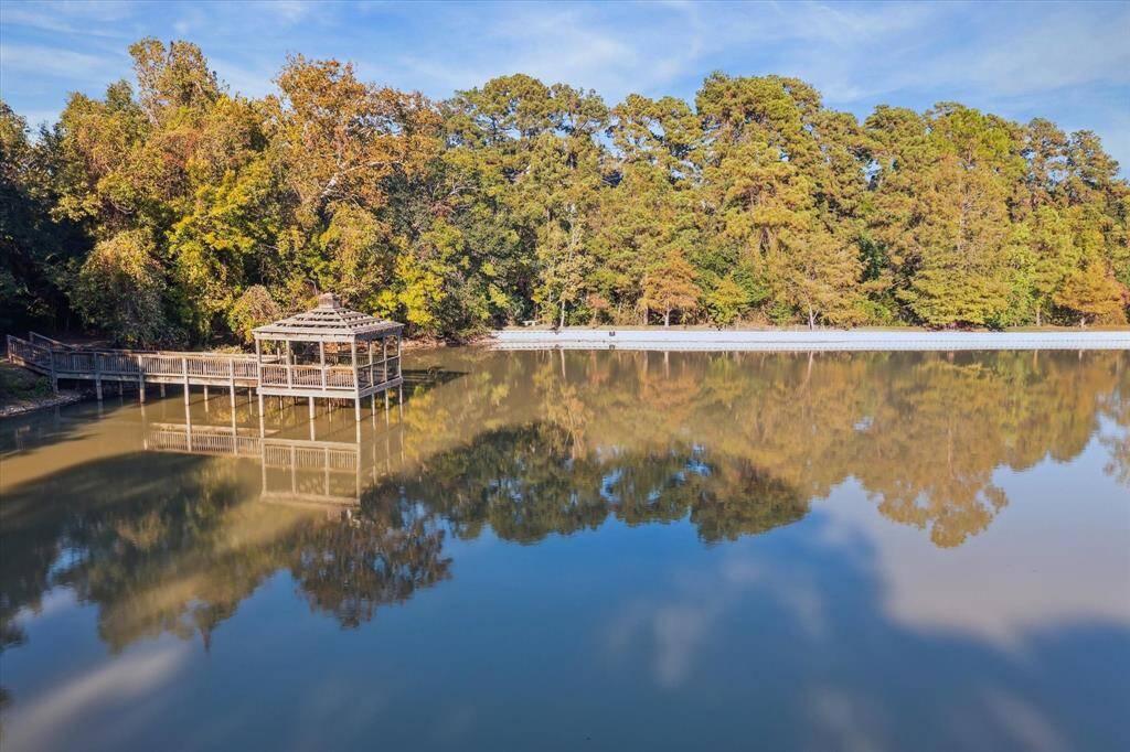 Private lake features a pier for fishing.