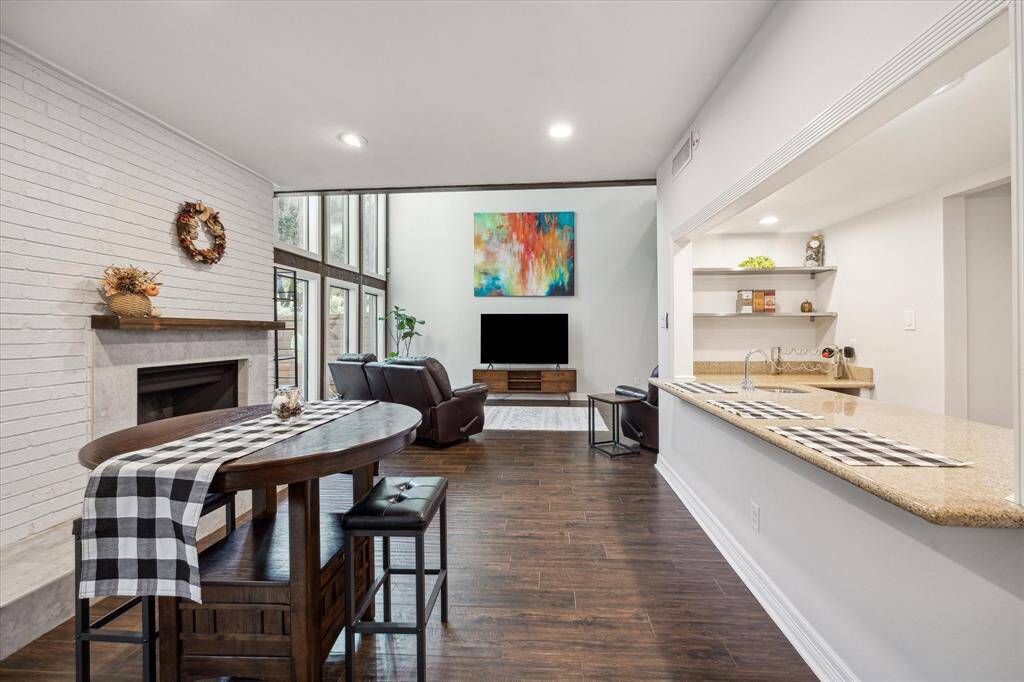 The first floor is all tile with a fireplace, wine bar and open concept floorplan.