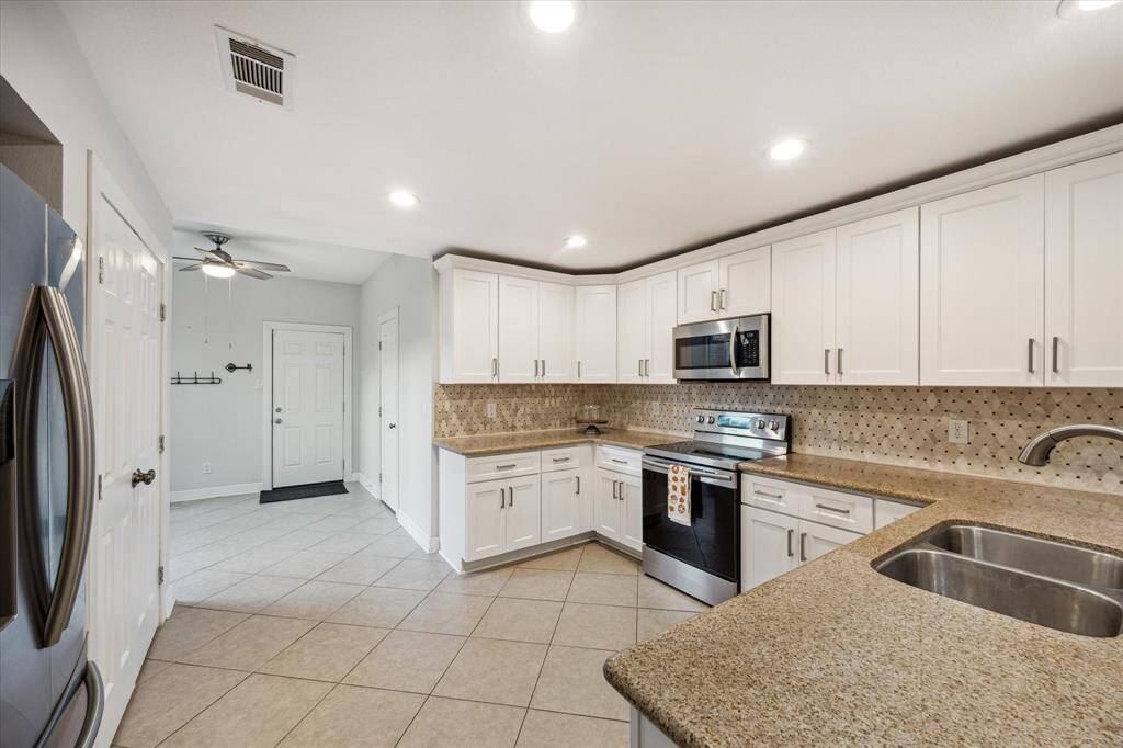The large kitchen has stainless steel appliances and a breakfast area which opens to the front deck.