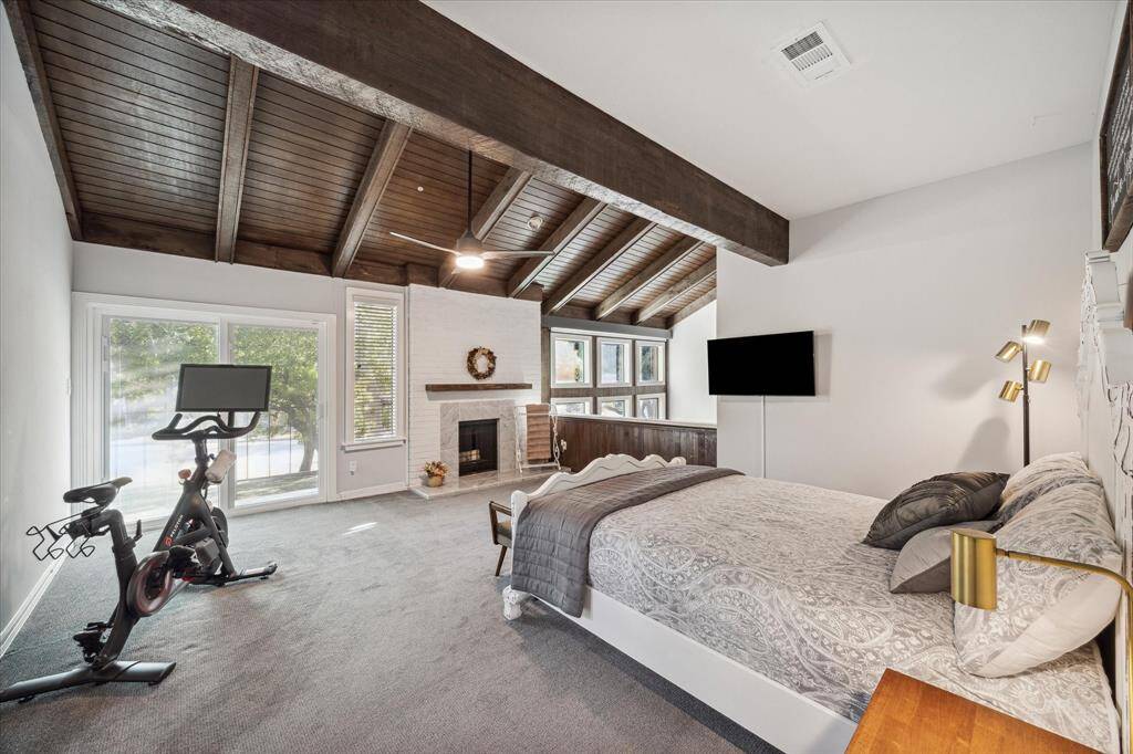 The primary bedroom loft is spacious and has a private balcony overlooking the backyard.