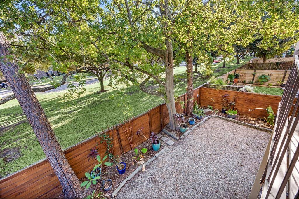 This is the view from the primary bedroom balcony. A great view with mature trees and no back neighbors.