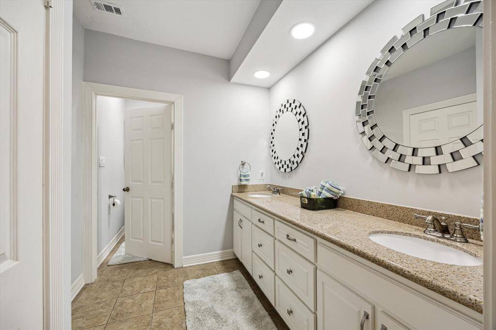 The primary en suite has two separate sinks and a water closet in addition to the walk in closet and tub/shower combo.