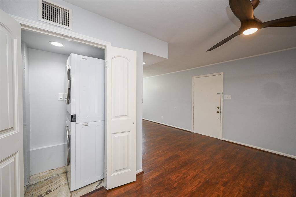 Featuring a Full Size stacked washer and dryer.