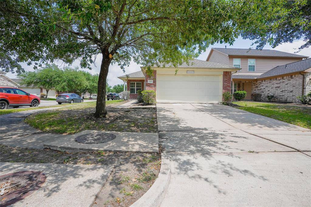 Charming single-story home with a two-car garage, set in a quiet neighborhood. The driveway offers ample parking, and the mature tree in the front yard provides shade and curb appeal.