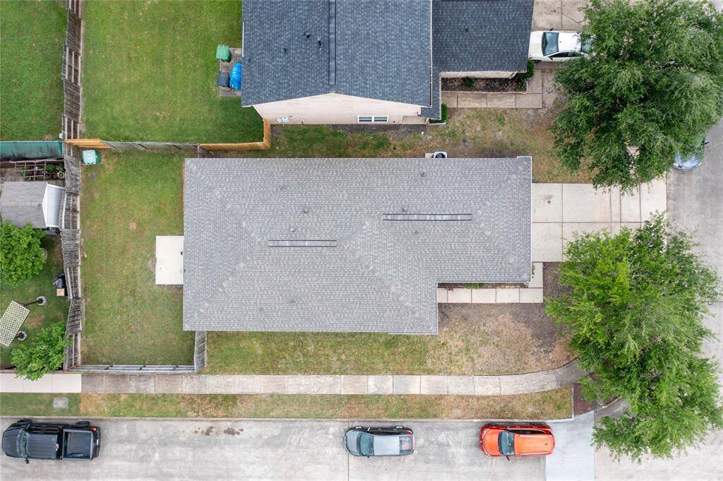 This photo shows a single-story brick house with a two-car garage. It features a clean driveway, a small front yard with some shrubs, and a welcoming front entrance. The neighborhood appears quiet and well-maintained.