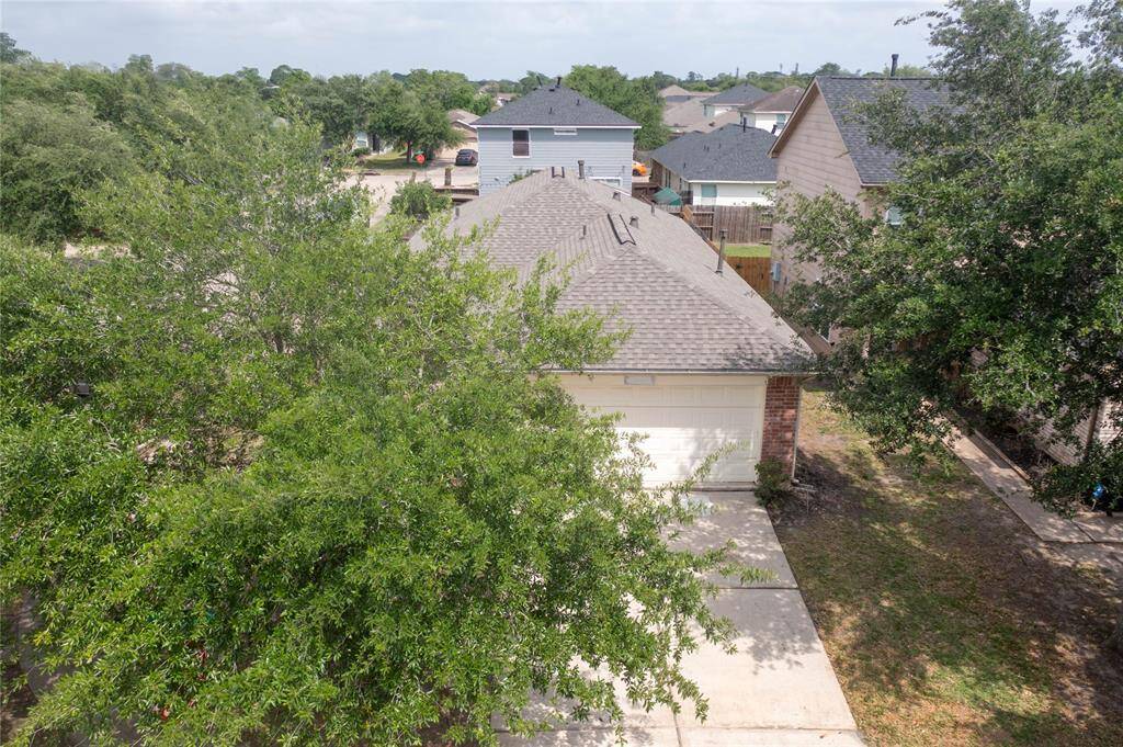 This photo shows a single-story brick house with a two-car garage. It features a clean driveway, a small front yard with some shrubs, and a welcoming front entrance. The neighborhood appears quiet and well-maintained.
