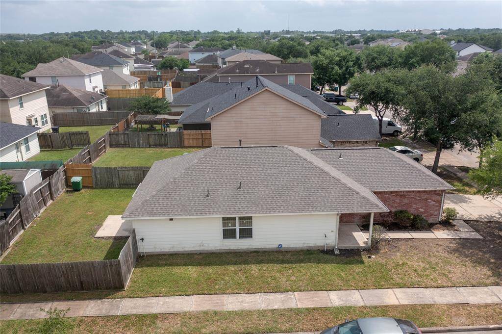 This photo shows a single-story brick house with a two-car garage. It features a clean driveway, a small front yard with some shrubs, and a welcoming front entrance. The neighborhood appears quiet and well-maintained.