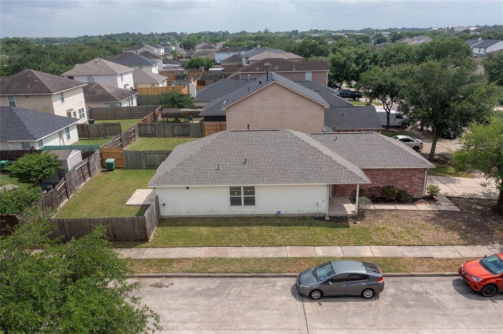 This photo shows a single-story brick house with a two-car garage. It features a clean driveway, a small front yard with some shrubs, and a welcoming front entrance. The neighborhood appears quiet and well-maintained.