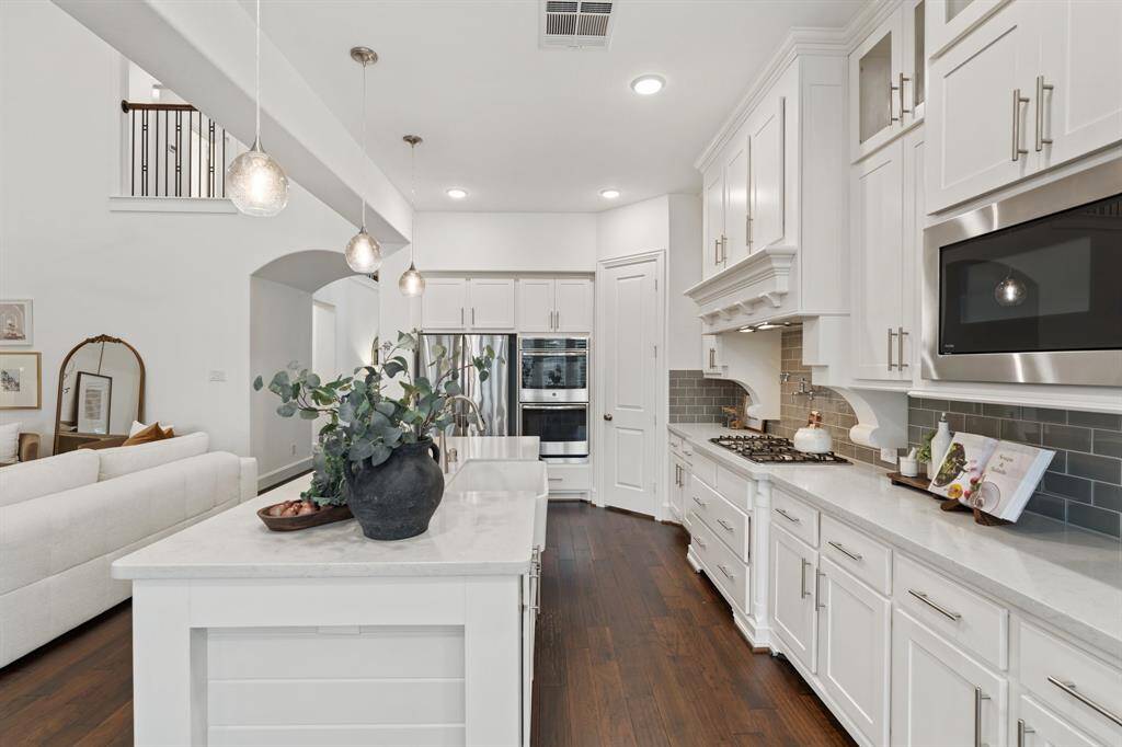 This kitchen also features custom cabinetry that goes all the way to the ceiling along with a large walk-in pantry.