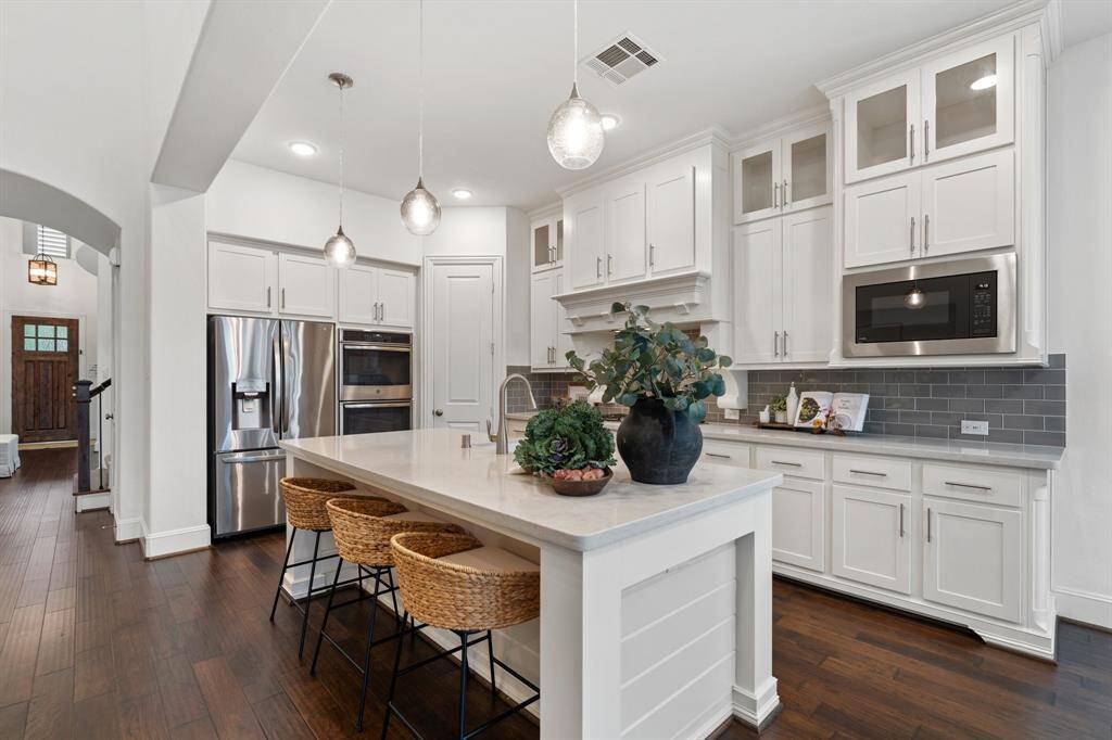 A generous island anchors the kitchen, offering ample space for additional seating.