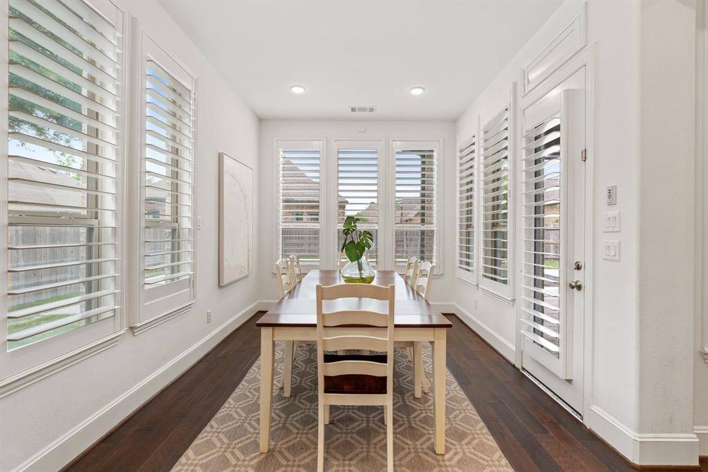 The breakfast room is flooded with natural light and overlooks the expansive backyard, pool and covered patio.