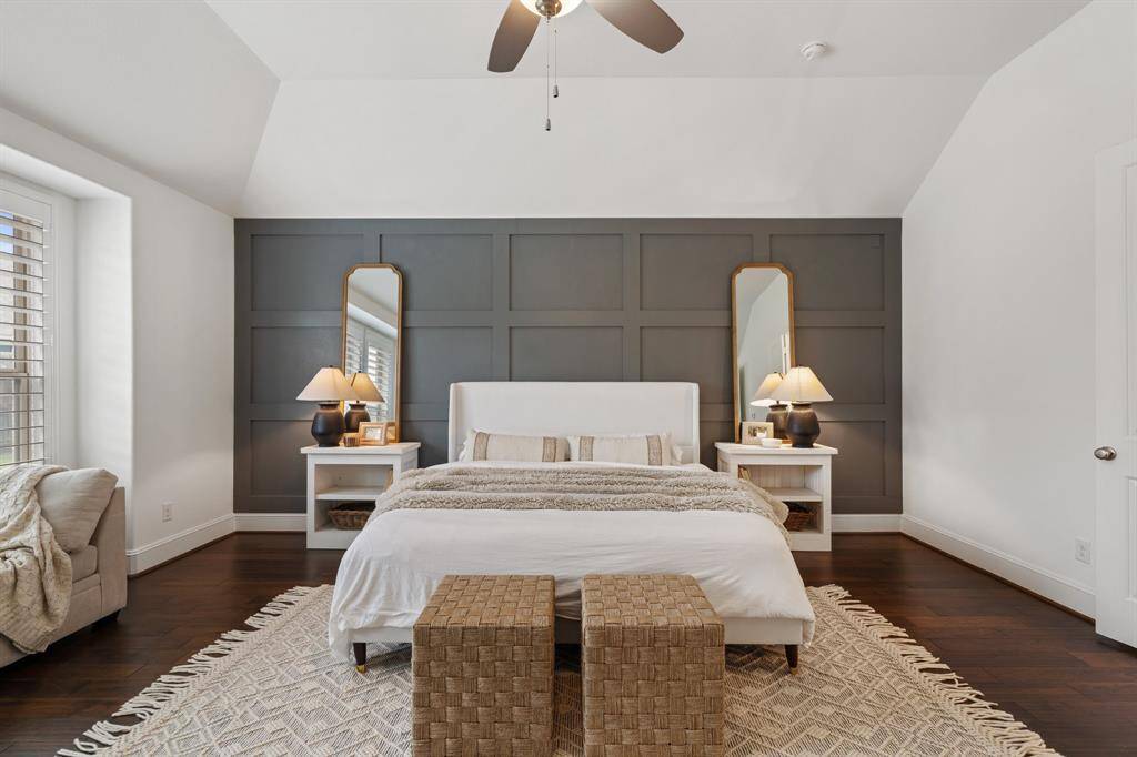 Another look at the serene first floor primary suite with sweeping views of the backyard and pool area.
