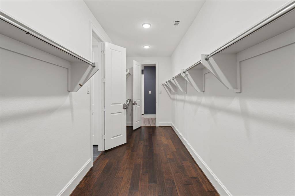 The primary suite's spacious closet conveniently connects to the laundry room.
