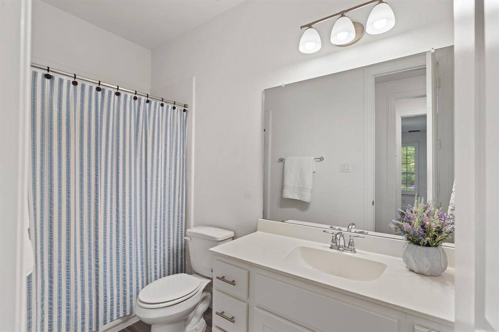 The full bathroom with a shower/tub combo.