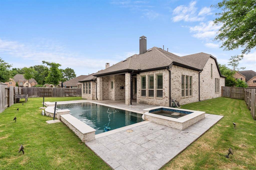 This sizable lot offers abundant green space in addition to the pool and covered patio area. Landscape lighting and a mosquito control system ensure you can enjoy this backyard in every season.