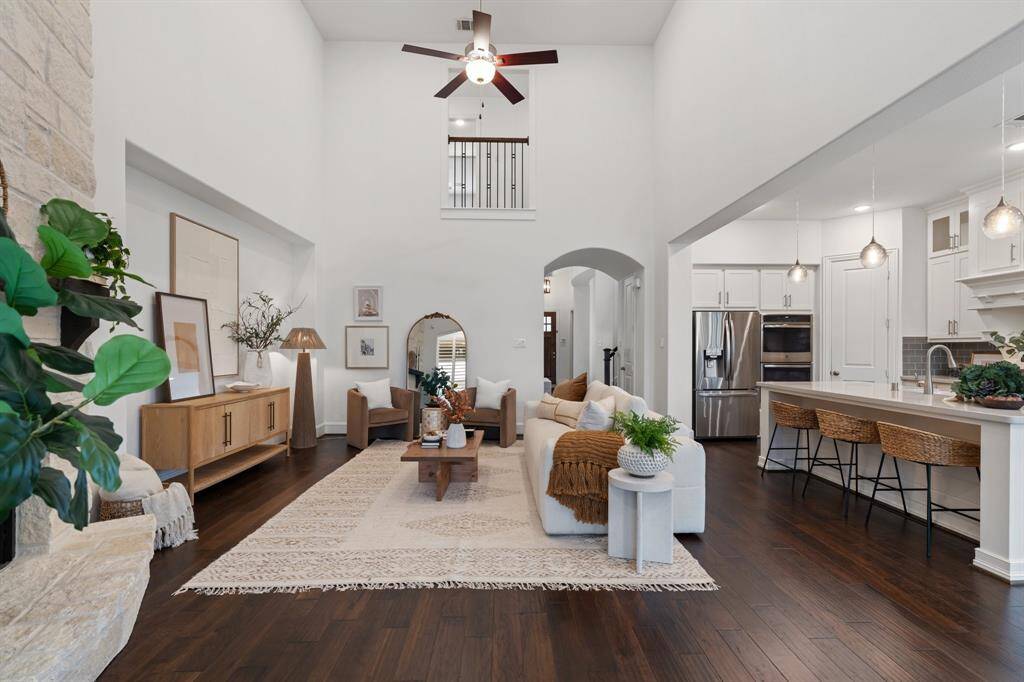The inviting living area is complete with soaring two story ceiling heights and a gas fireplace providing a cozy spot for relaxation.