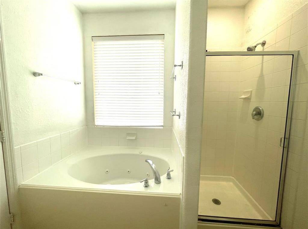Primary walk-in shower and jetted tub