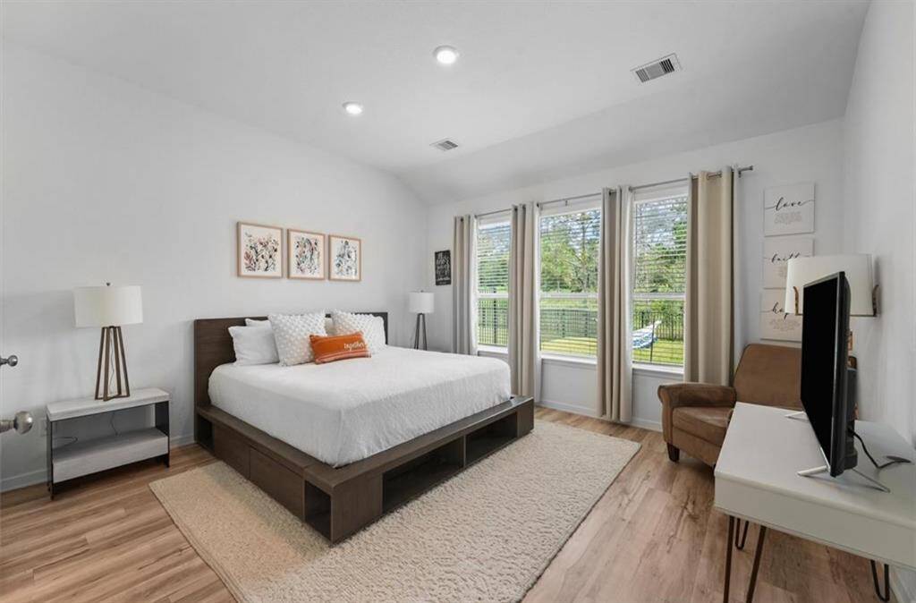 The spacious primary suite is a true retreat—filled with natural light, calming tones, and plenty of room to make it your own.