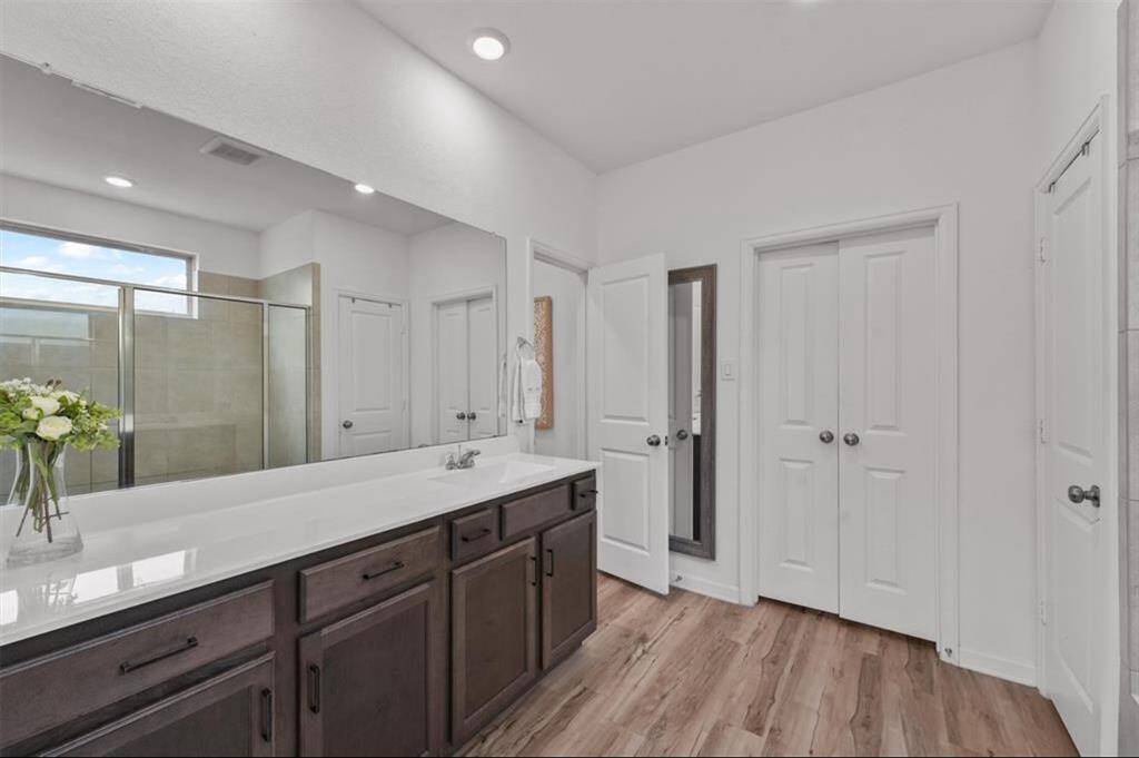 Modern finishes meet spa-like comfort with a double vanity, walk-in shower, and plenty of storage in this beautiful en-suite bathroom.