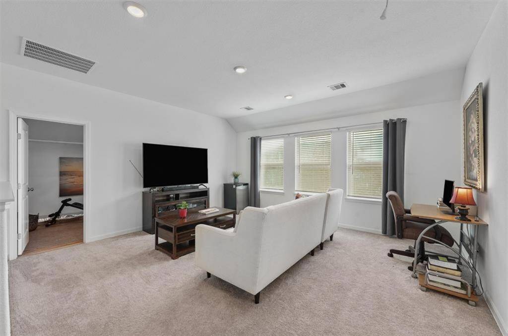 Upstairs game room offers extra space to play, work, or lounge—perfect for movie nights, gaming, or a home gym setup.