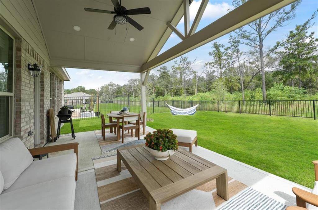 This covered patio is ready for all seasons! String up some lights, add comfy seating, and have the ideal spot for evening hangs or peaceful outdoor dinners.