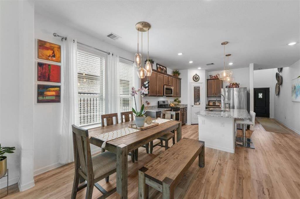 Enjoy meals in style in the cozy dining area with views of the backyard and open connection to the kitchen and living room.