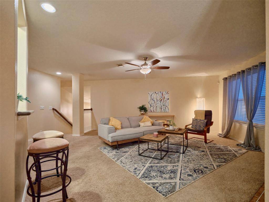 Spacious living room greets you at the top of the stairs.