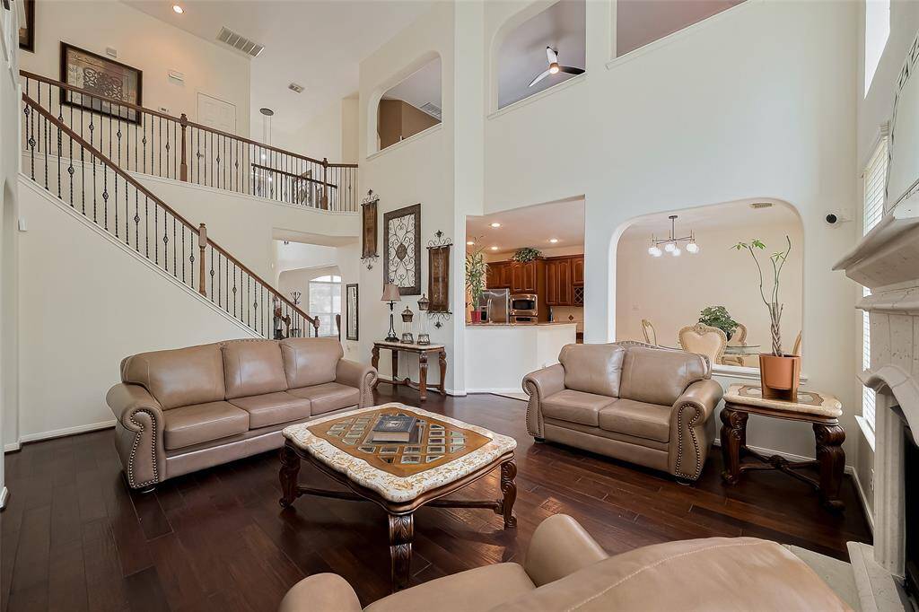 The living space is stunning with the gorgeous details of the stairwell railing.