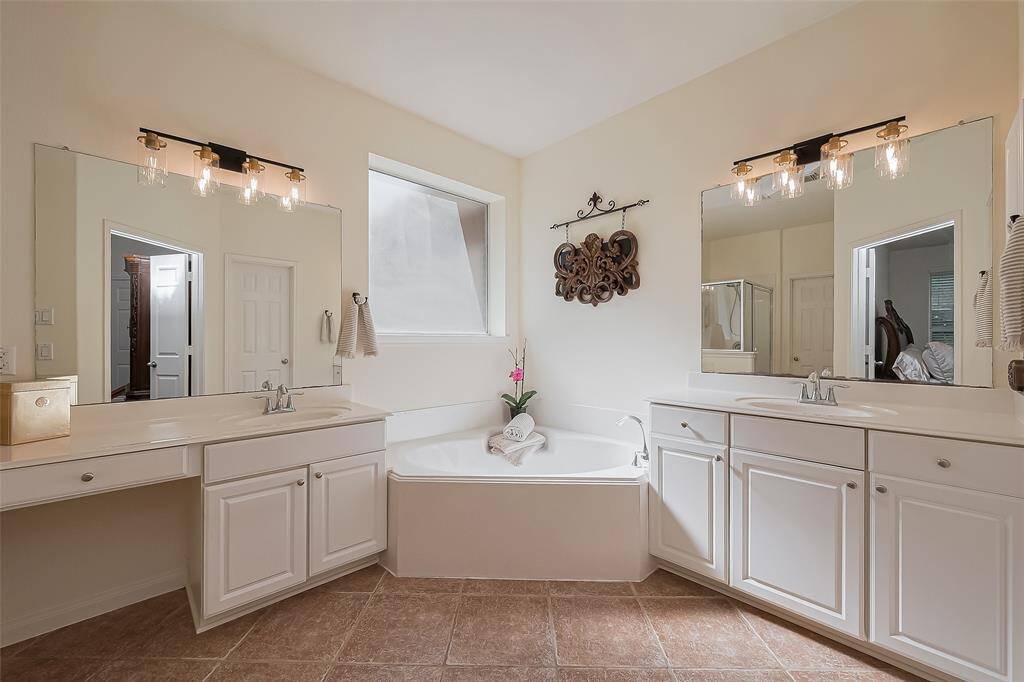 En suite spa-like bath with soaking tub and double sinks.